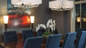 modern dining room with a dark wodden table and royal blue chairs.