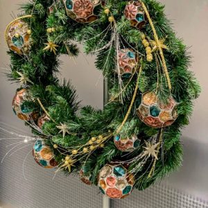 green holiday wreath hanging on a door