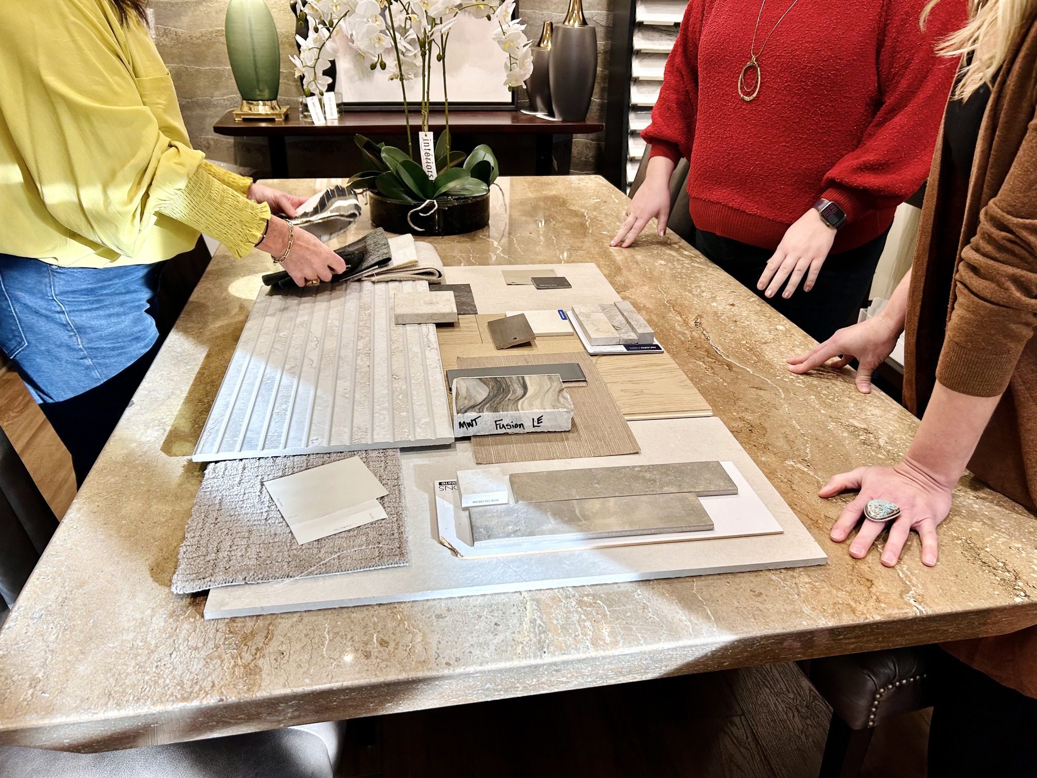 a group of interior designers collaborate on a design on a table