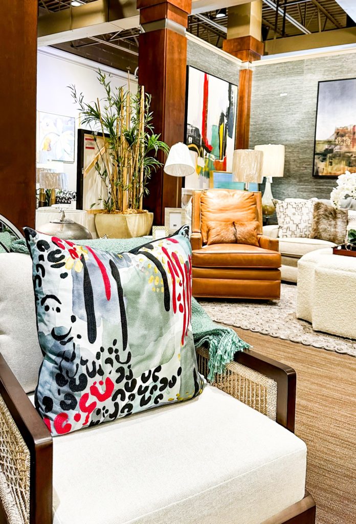 showroom at interiors joan and associates with a colorful pillow on a single chare