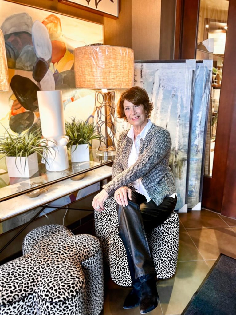 an interior designer at interiors joan and associates poses in the showroom